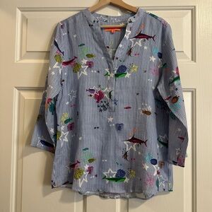 Blue and white striped long sleeve shirt with a funky fish and star design